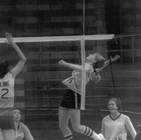 McAffee jumping, ready to spike the volleyball over the net