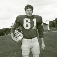 Williams posed with helmet tucked under right arm, wearing #61