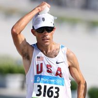 Dunn resting one arm on top of his head at the end of a race