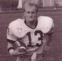 Nielson runs holding the football under his left arm helmet
