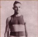 Massopust stands in front of a white backdrop in a striped uniform