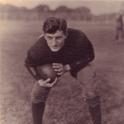 Simso crouches, ready to run with the football