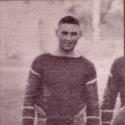 Keller stands smiling in his football uniform
