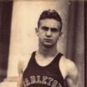 Norldy stands in front of Sayles-Hill campus center with his hand behind his back