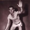 Thurnblad poses, knees bent arms spread