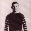 Markley stands in his football uniform in front of a white background