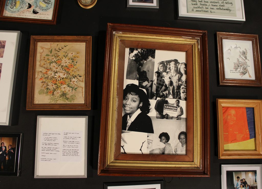 A collection of framed photos, artworks, and other ephemera