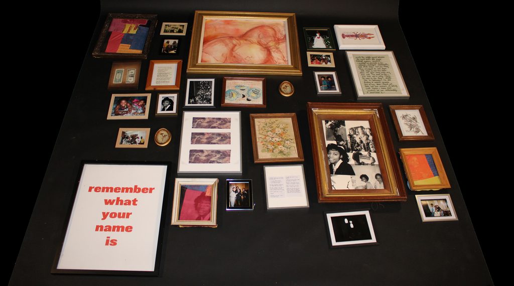 A collection of framed photos, artworks, and other ephemera