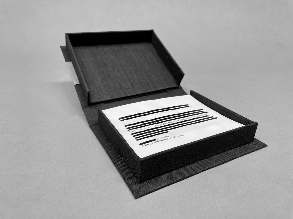 open portfolio box with printed pages inside