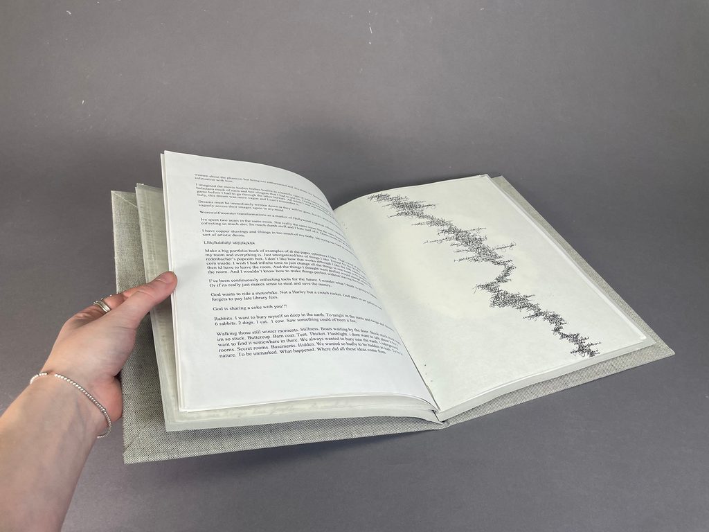 handmade book with printed illustrations and handwritten text