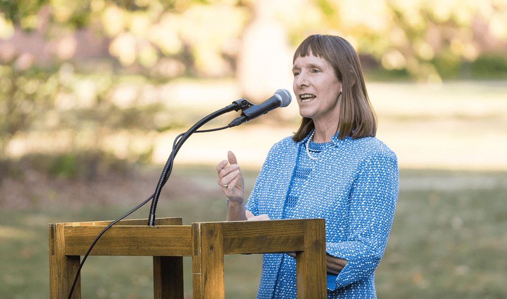President Byerly speaking at a podium outdoors