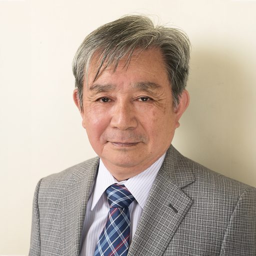 Headshot of Japanese Man in gray suit.