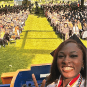 student speaker takes a selfie on stage