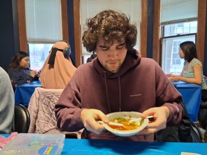TRIO Peer Leader, Robert Los, enjoys a bowl of Pho at the Fiesta Friday #1: Pho & Fun event