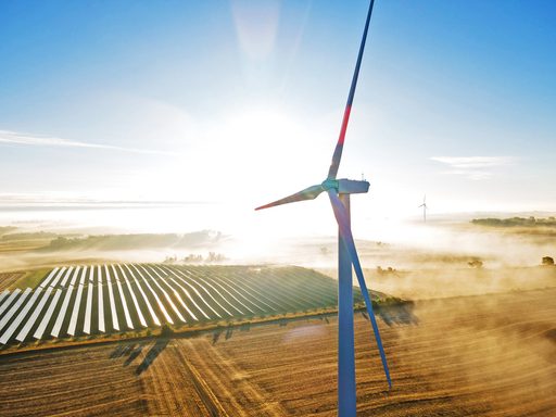 Drone shot of a Carleton wind turbine on a foggy morning