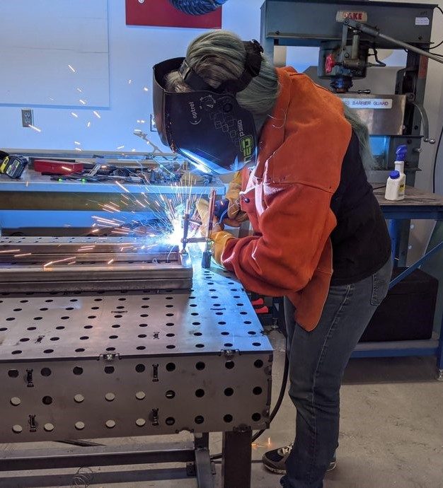 PERSON WELDING IN THE MAKERSPACE