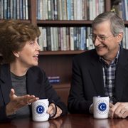 Cathy Paglia and Wally Weitz pose with Carleton coffee mugs