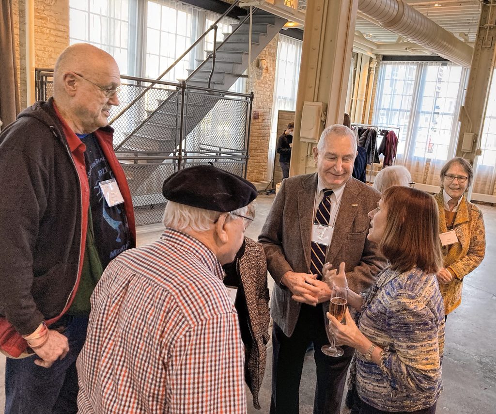 Group of 4 adults talking in a circle