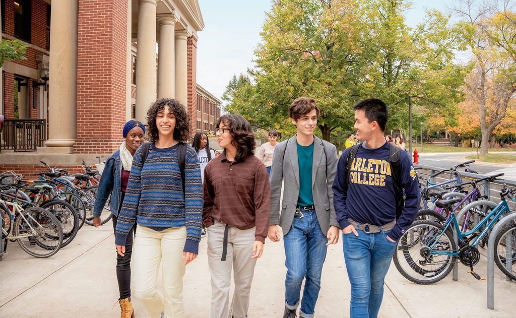 group of four students walking outside Sayles