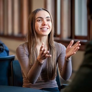 A student having an animated conversation with another student