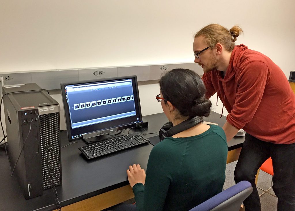 Two students using a computer in the perception lab.