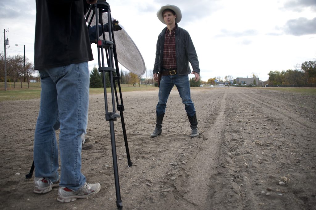 studnet standing in cowboy costume facing a video camera